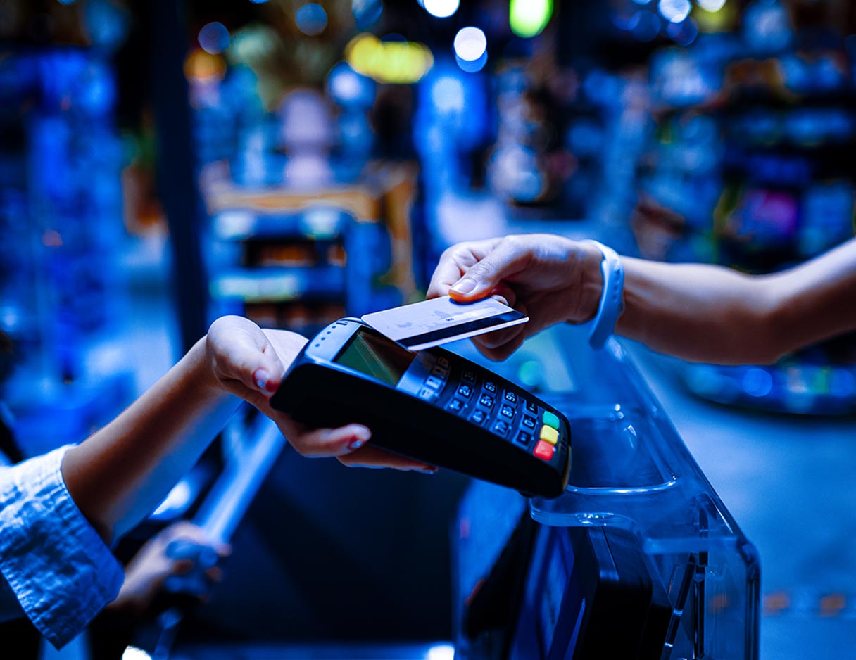 Image of people paying via a mobile device and CC